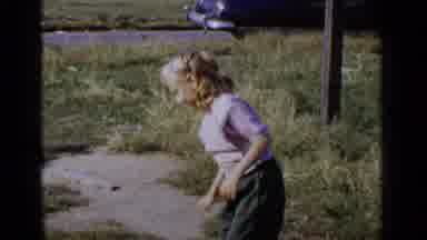 New York (1951): Kid Bouncing Her Ball In The Grass Then Kid Riding His Tricycle