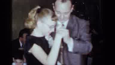 New York (1954): Girl Wearing Black Dress Dances With Man Wearing Grey Suit