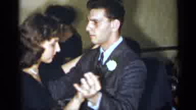 New York (1954): Woman Wearing Black Dress Dances With Man Wearing Grey Suit