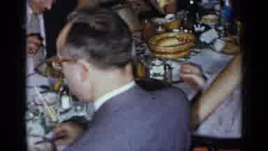 New York (1954): Guests Seated At Long Table Turn To Camera Then Man Directly At