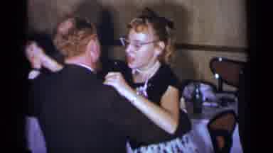 New York (1954): A Man In A Suit And A Woman In A Dress Dancing Surrounded By