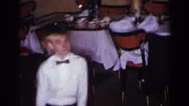 New York (1954): Boy In A White Shirt And Bow Tie Dancing In Circles At A Dinner