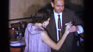New York (1954): A Happy Couple Dancing Together At A Family Gathering With Lot Of