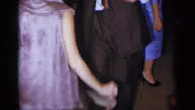New York (1954): A Couple In A Suit And Tie Dancing Together In A Room Full Of