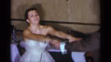 New York (1954): Woman Wearing Blue Dress Dances With Man Wearing Blue Suit