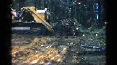 Birmingham Alabama (1957): Man Using A Yellow High Lift To Clear Brush And Move