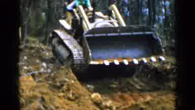 Birmingham Alabama (1957): Man Wearing Green Shirt Operates Yellow Bulldozer On A