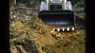 Birmingham Alabama (1957): Man Moving Dirt With A Bulldozer Near The Wood On A