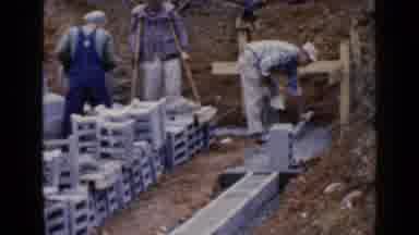 Birmingham Alabama (1957): People Stacking Concrete With Cement Building Something