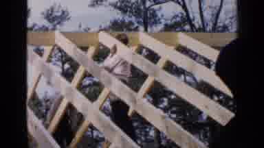 Birmingham Alabama (1957): Person Wearing Blue Pants Hammers Two By Fours Onto