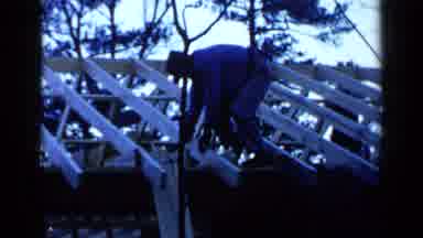 Birmingham Alabama (1957): A Man In A Hat Working On An Unfinished Roof With A