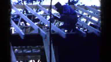 Birmingham Alabama (1957): Worker On A Rooftop Hammering The Beams As He Walks