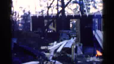 Birmingham Alabama (1957): Man Wearing Blue Shirt Hammers Wood On House Frame On A