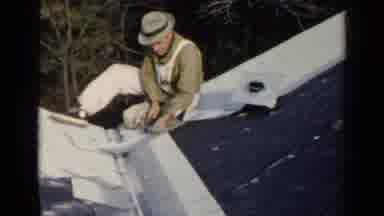 Birmingham Alabama (1957): A Man Fixing The Roof Of A House With A Hammer
