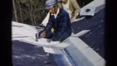Birmingham Alabama (1957): Man In Plaid Shirt Working On Roof Using A Hammer