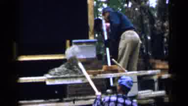 BIRMINGHAM ALABAMA-1957: Bricklayers Standing On A Scaffold Putting Mortar On