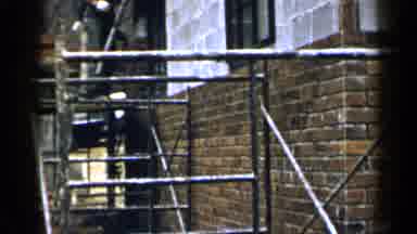 Birmingham Alabama (1957): Men Laying Brick And Mortar While Standing On
