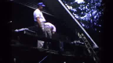 Birmingham Alabama (1957): Two Men Standing On A Roof Top Performing Work With