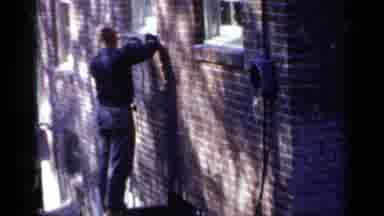 Birmingham Alabama (1957): Man Using A Power Tool To Work On The Side Of A Brick