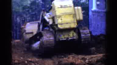 Birmingham Alabama (1957): Man Wearing Green Shirt Operates Yellow Bulldozer On A