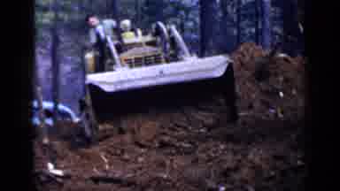 Birmingham Alabama (1957): Man Wearing Green Shirt Operates Yellow Bulldozer On A
