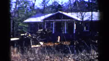 Birmingham Alabama (1957): Person Operating Yellow Bulldozer Near Brown House On A