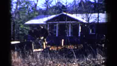 Birmingham Alabama (1957): Bobcat Clears Bush Around Home