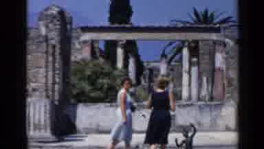 Rome Italy (1960): Two Female Tourists Walk Slowly Through A Magical Old Ruin