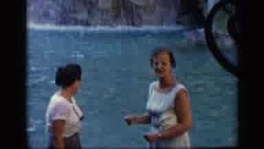 Vatican Italy (1960): A Woman In A Blue Dress Sits Beside A Body Of Water Feeding