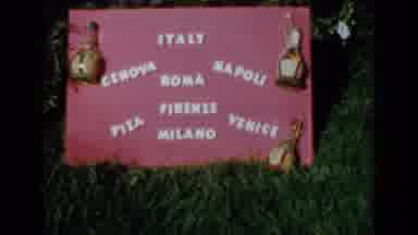 Venice Italy (1960): A Red Sign That Has Italy And Other Words And Pictures On It