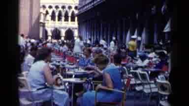Venice Italy (1960): Women Wearing Blue Dresses Sit At Outdoor Cafe On A Clear Day