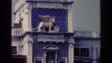 Venice Italy (1960): A Gryphon Stands Watch Out Side A Building While Birds Circle