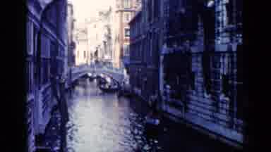 Venice Italy (1960): Gondolier Rowing Couple In A Gondola Down A Water Street