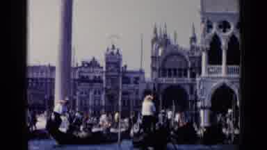 Venice Italy (1960): Male Gondoliers Row Gondolas Along A Crowded Waterway In