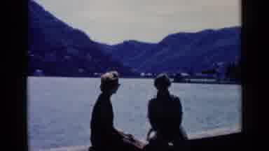 Venice Italy (1960): View Of White Bench And Red Flowers Near Water On A Bright