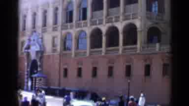 Venice Italy (1960): Green Car Drives Past Yellow And Orange Building On A Bright