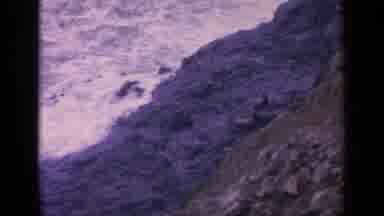 California USA (1963): The White Ocean Waves Smash Into The Rocks Of The Shore