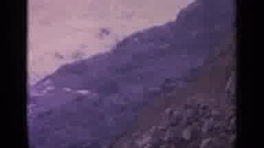 California USA (1963): Rocky Beach Waves Beat At Rocks And Debris Along Shore