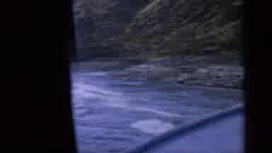 Idaho USA (1963): Boat Following Jet Ski Going Fast On The Water Near The Shore