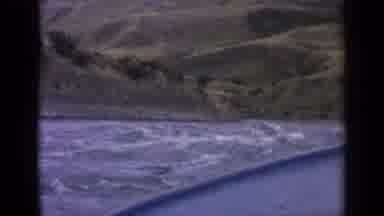 Idaho USA (1963): Boat Floats On Small White Caps Towards A Shore Of Small Green