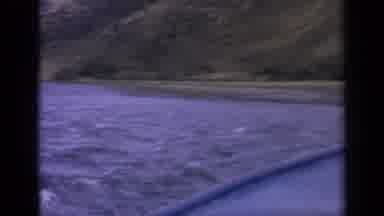 Idaho USA (1963): Small Boat Floats Across Choppy Water While Looking Around