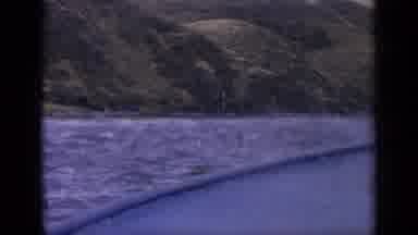Idaho USA (1963): Person Filming From Boat Driving In The Lake Towards Shore