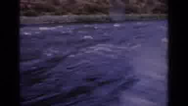 Idaho USA (1963): Passing View Of Green Mountains And Blue Lake Water On A Clear