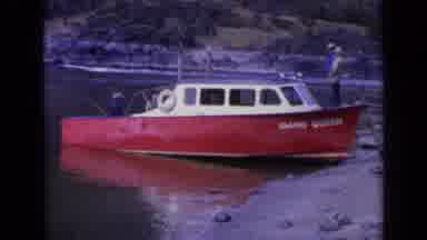 WASHINGTON USA-1963: Red Fishing Boat Idaho Queen At Rocky Shoreline