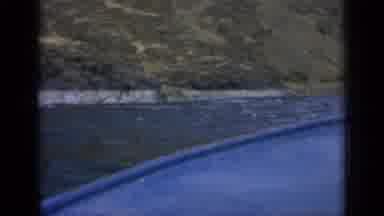 Washington USA (1963): Blue Boat Coasting Along A Riverside By The Mountains