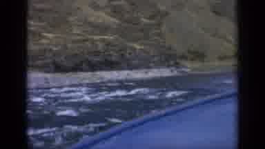 Washington USA (1963): A Boat Floating In Choppy Water In The Mountains Outside