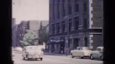 Chicago Illinois (1957): 1950s Looking Car Travelling Along A Down Town Avenue