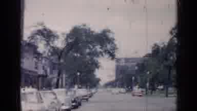 Chicago Illinois (1957): In A City Downtown There Are Cars Parked And Cars Driving