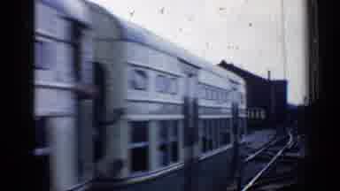 Chicago Illinois (1958): A Train Leaving A Small Station Crossing An Intersection