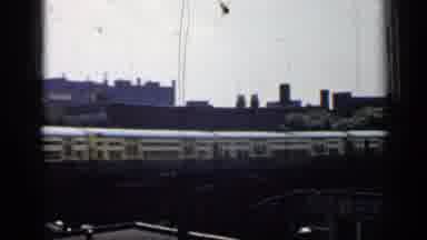 Chicago Illinois (1958): Train Passing By Along With People Loading On The Dock
